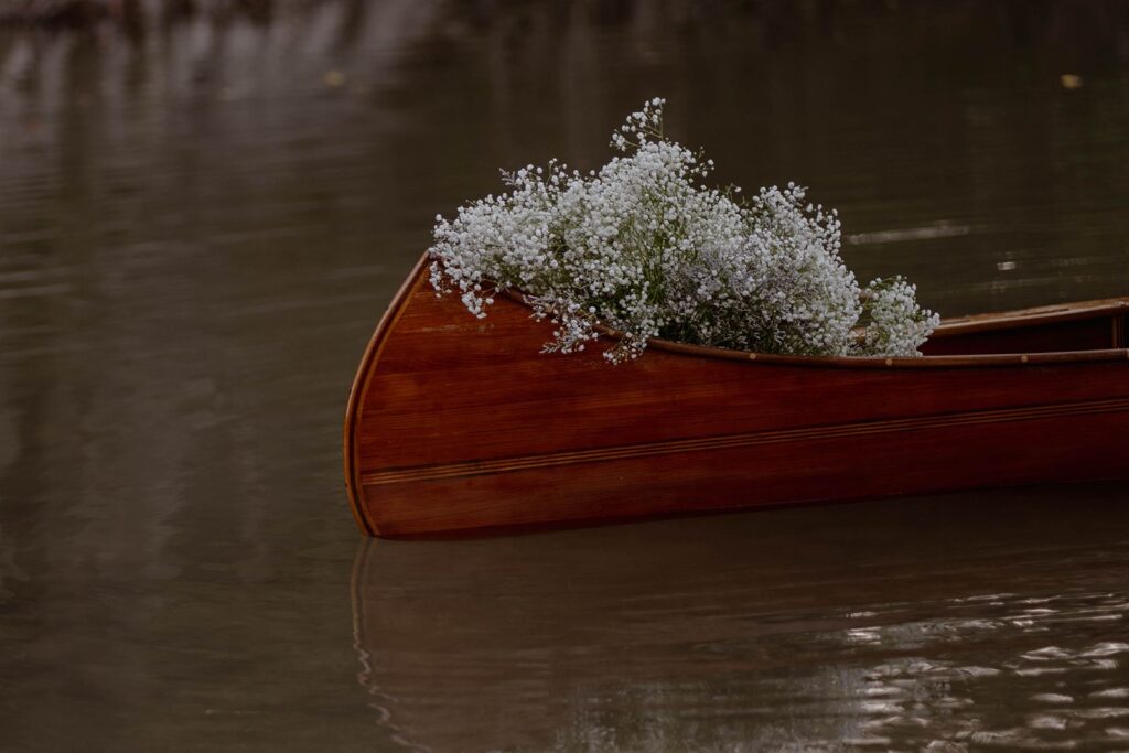 flowers in wedding canoe for the couple's Texas hill country elopement.